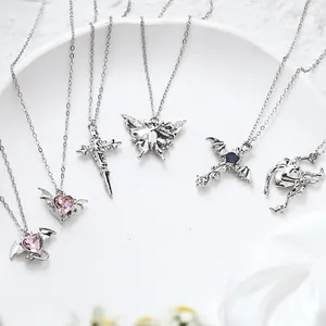 Multiple silver alloy necklaces featuring pink heart crystals, cross and butterfly pendants.