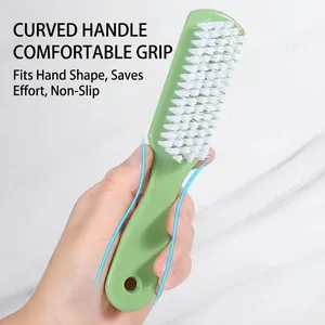 Ergonomic green plastic shoe brush with stiff white bristles for laundry and cleaning