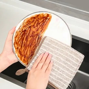 Absorbent microfiber kitchen dishcloth cleaning oily stains from a ceramic plate