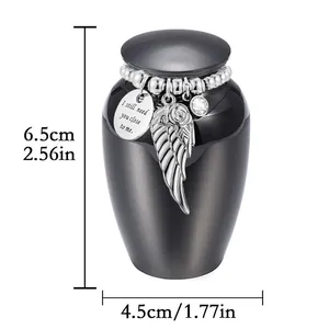 Detail view of small black memorial urn with angel wing charm and exact dimensions