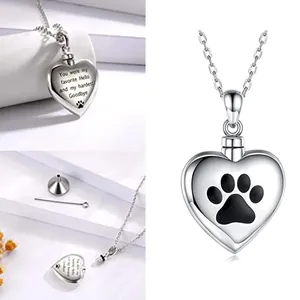 Detailed view of stainless steel heart cremation urn necklace with paw print and memorial engraving