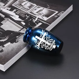 Close-up detail of polished blue keepsake urn with engraved white cross and Forever text