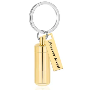 Detailed macro view of a golden cylindrical urn keychain with Forever loved text