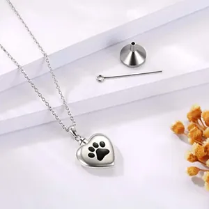 Heart-shaped stainless steel pet cremation jewelry necklace with paw print and funnel kit.