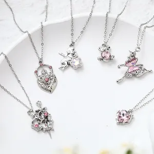 Assorted silver-plated necklaces featuring pink crystal heart, butterfly, and angel pendants.