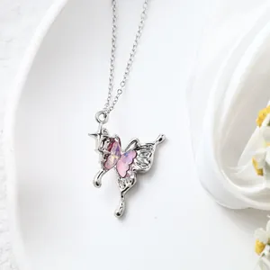 Close-up detail of Y2K style silver butterfly necklace pendant with pink crystal.