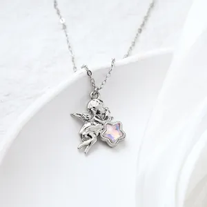 Macro view of silver cherub angel pendant necklace holding a pink opal star gem