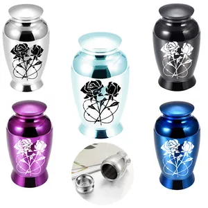 Close-up of alloy mini urns featuring rose patterns and various metallic finishes.