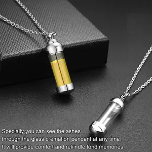 Close-up of a glass cremation pendant necklace showing ashes inside for memorial.