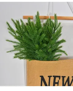 Detail of soft touch artificial Norfolk pine needles in a rustic hanging burlap pocket