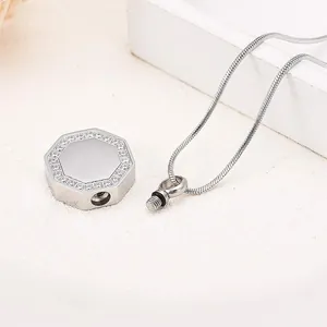 Detail view of silver hexagonal cremation urn pendant with rhinestones and screw-top opening.