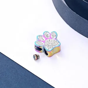 Close-up of rainbow stainless steel paw urn pendant with rhinestone detail and screw cap