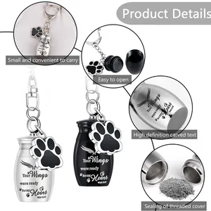 Detailed view of pet memorial cremation urn keychains with engraved sentiment and paw charm.