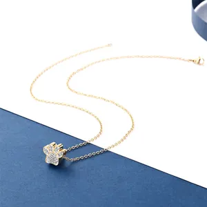 Detailed view of a gold-plated paw print pendant encrusted with sparkly crystals