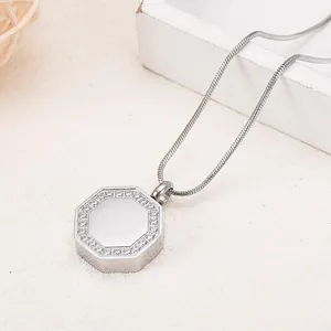 Detail view of a silver hexagonal cremation urn pendant necklace with tiny rhinestones