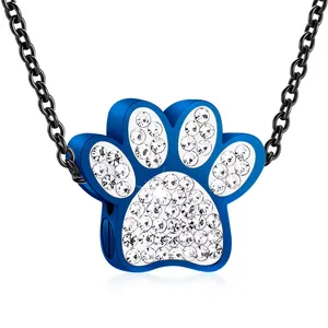 Close-up detail of blue stainless steel paw shaped cremation pendant with white rhinestones
