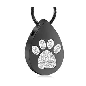 Macro view of black teardrop cremation pendant with crystal paw print detail