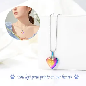 Close-up of rainbow heart pet cremation necklace with paw print and sentimental quote