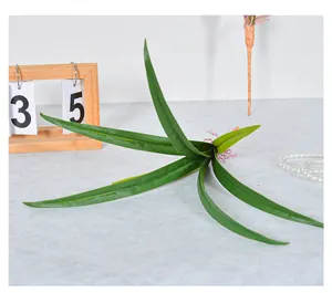 Detailed view of artificial green orchid leaves for floral arrangements and home decor