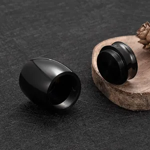 Detail of a small black aluminum alloy memorial urn for pet ashes with threaded lid.