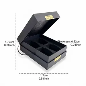 Macro detail of a small black cremation jewelry box with dimensions and gold clasp