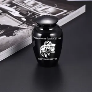 Detailed view of a small black memorial urn with a unique fishing fish engraving for pet ashes