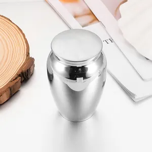 Polished silver aluminum alloy pet urn for ashes and hair keepsakes macro view.
