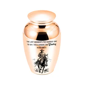 Detailed view of a rose gold memorial cremation urn with cowboy engraving and quote.