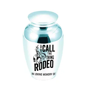 Close-up detail of white aluminum memorial urn featuring a cowboy rodeo illustration