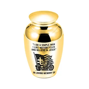 Close-up of golden cremation urn with motorcycle and faith engraving