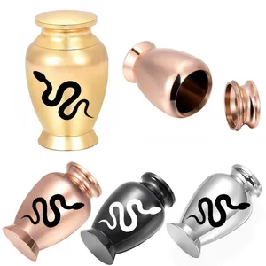 Detail of mini aluminum keepsake urns with snake pattern in various metal finishes.