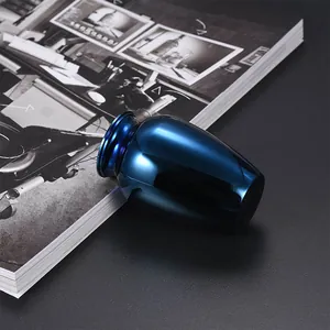 Close-up of a smooth deep blue aluminum pet cremation urn for ashes on a textured background