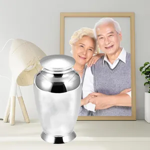 Silver polished small keepsake cremation urn for human or pet ashes in a home setting