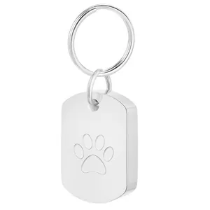Macro detail of polished stainless steel pet urn keychain with engraved paw print design