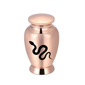 Close-up of rose gold aluminum cremation urn with black snake pattern