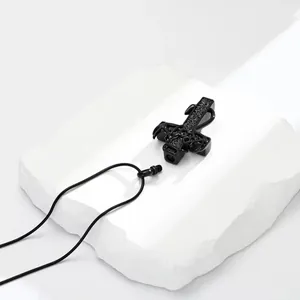 Close-up detail of black antler cross urn pendant with screw-top opening mechanism