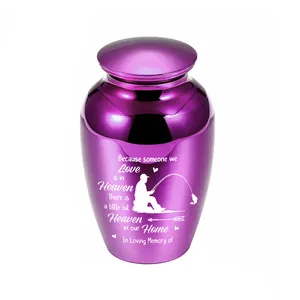 Macro view of small purple memorial urn featuring an engraved fishing silhouette