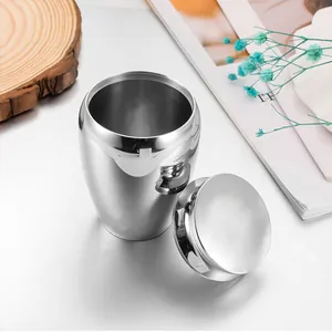 Close-up of polished stainless steel funeral urn for ashes with a secure threaded lid.
