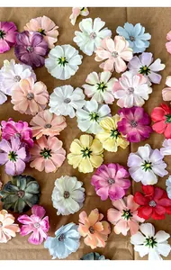 Detailed view of colorful mini artificial silk daisy flower heads for DIY crafts