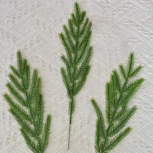 Lifelike artificial Norfolk pine needle branches for professional Christmas decoration.