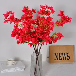 Vibrant magenta artificial bougainvillea silk flowers in glass vase for home decor