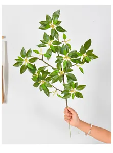 Close-up of lifelike artificial Japanese Andromeda branch with lush green leaves