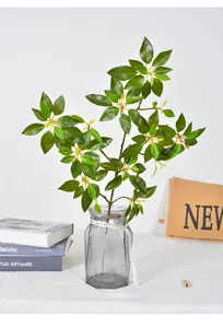 Realistic artificial Japanese Andromeda branch in a geometric grey glass vase home decor