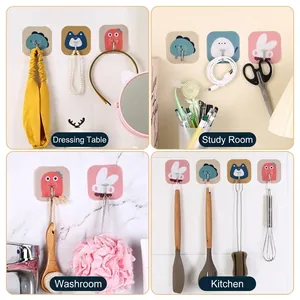 Set of 4 cute cartoon adhesive wall hooks for kitchen and bathroom organization.