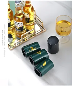 Detail view of automatic beer bottle openers in dark green and matte black with gold patterns.
