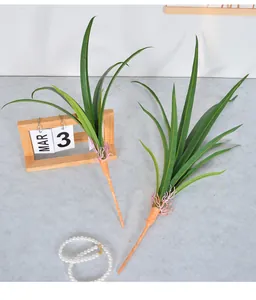 Detailed view of artificial Cymbidium leaves with realistic root texture and green blades