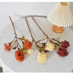 Detailed view of artificial skimmia berry clusters in warm autumnal shades for home decor.