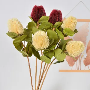 Realistic artificial red and cream Banksia flowers with green leaves for home decor