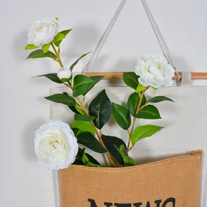 Realistic 4-head white artificial camellia flowers in a hanging canvas bag for home decor