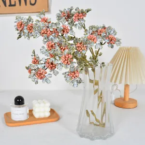 Vintage autumnal artificial berry branch in glass vase for cozy home interior decor